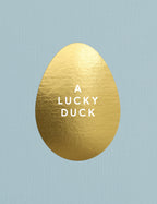 Gold egg-shaped object with 'A Lucky Duck' text on a light blue background