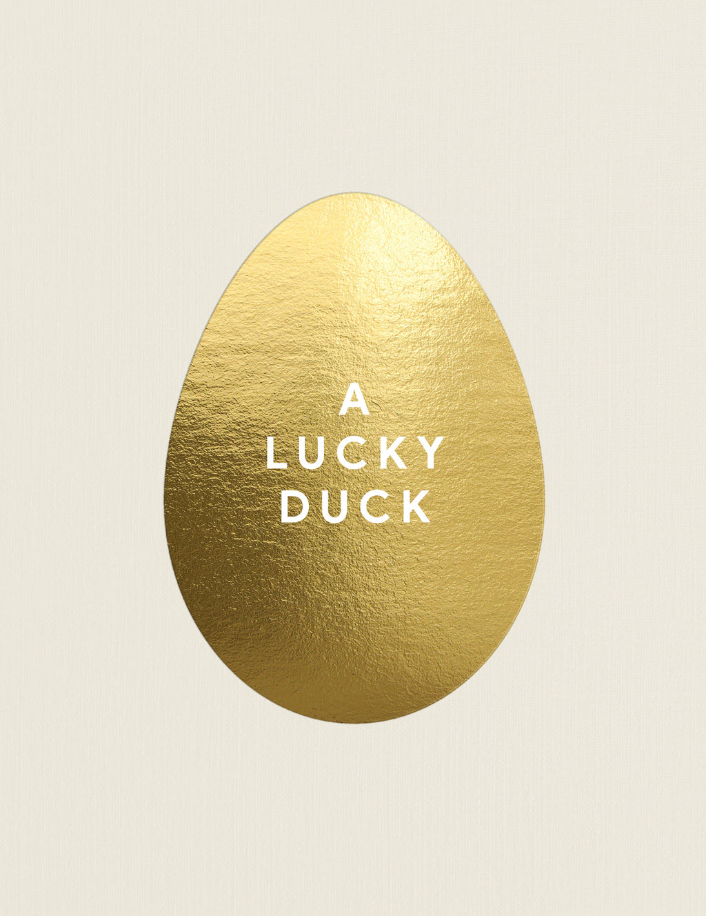 Gold egg-shaped object with 'A LUCKY DUCK' text on a beige background