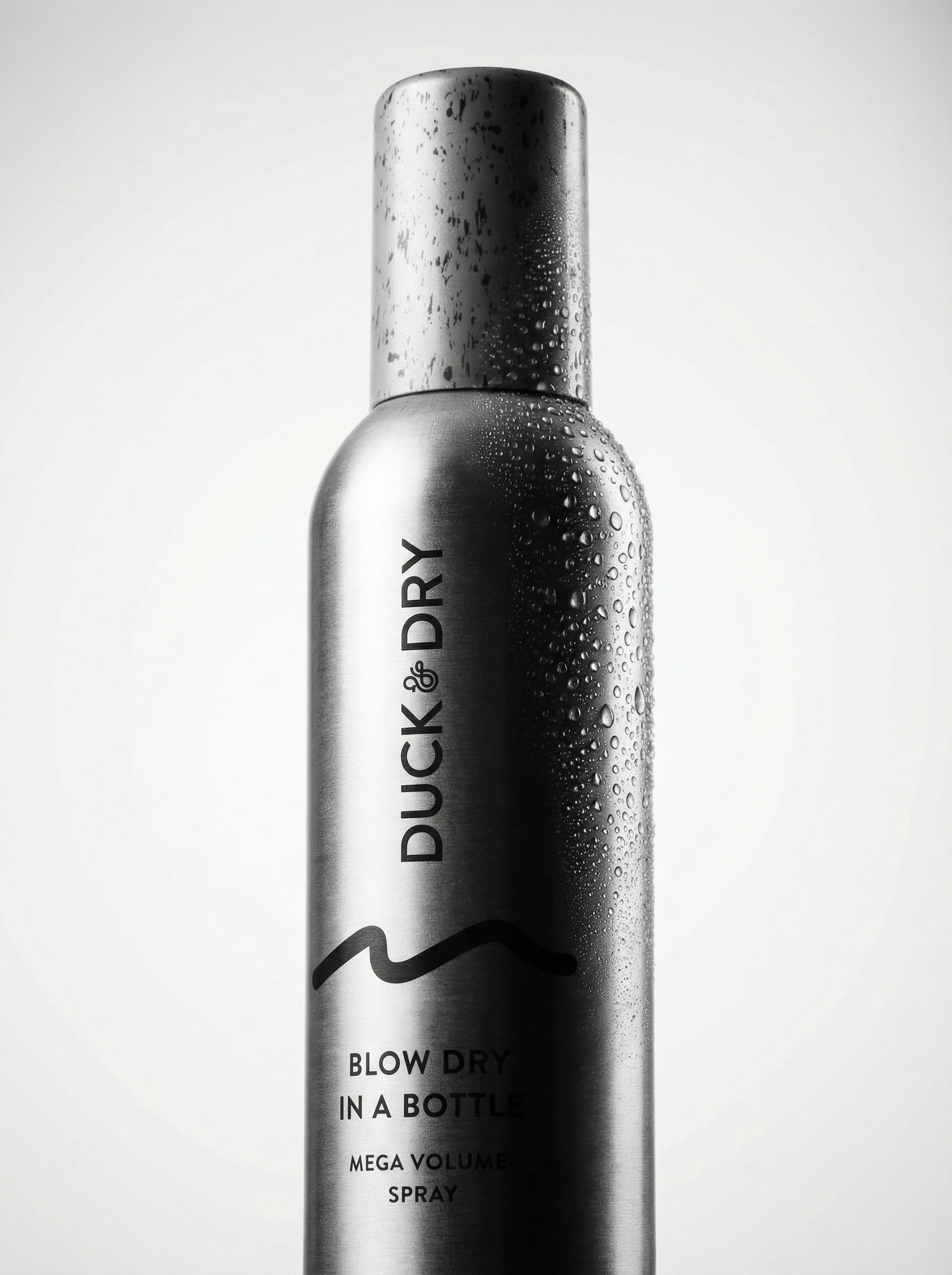 Silver spray bottle labeled 'Duck Dry' on a light gray background