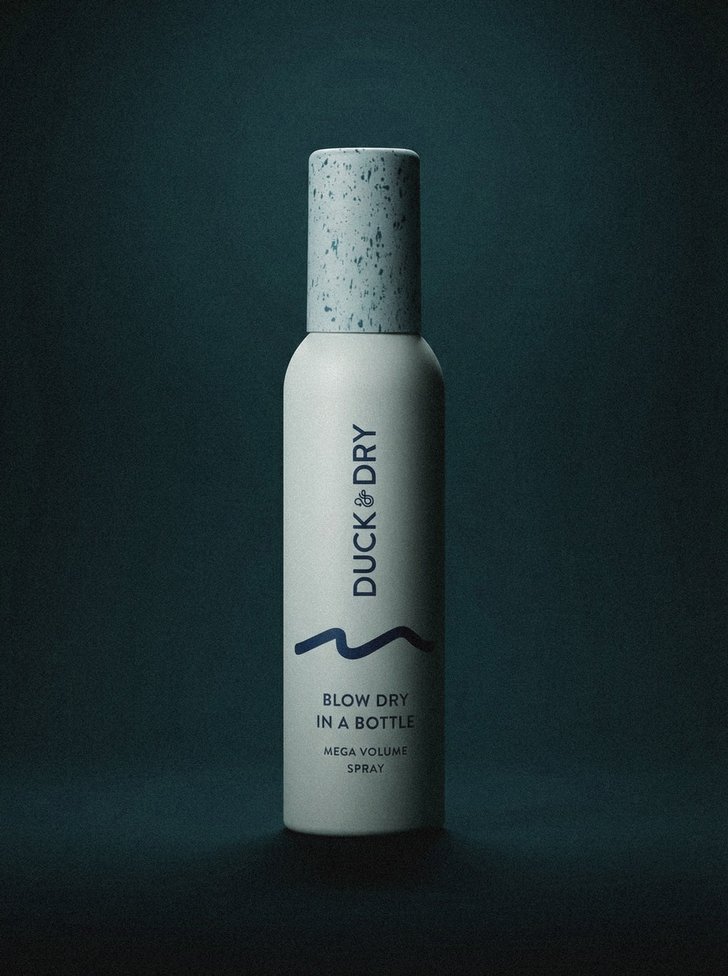 Bottle of 'Duck & Dry' hair product on a dark background