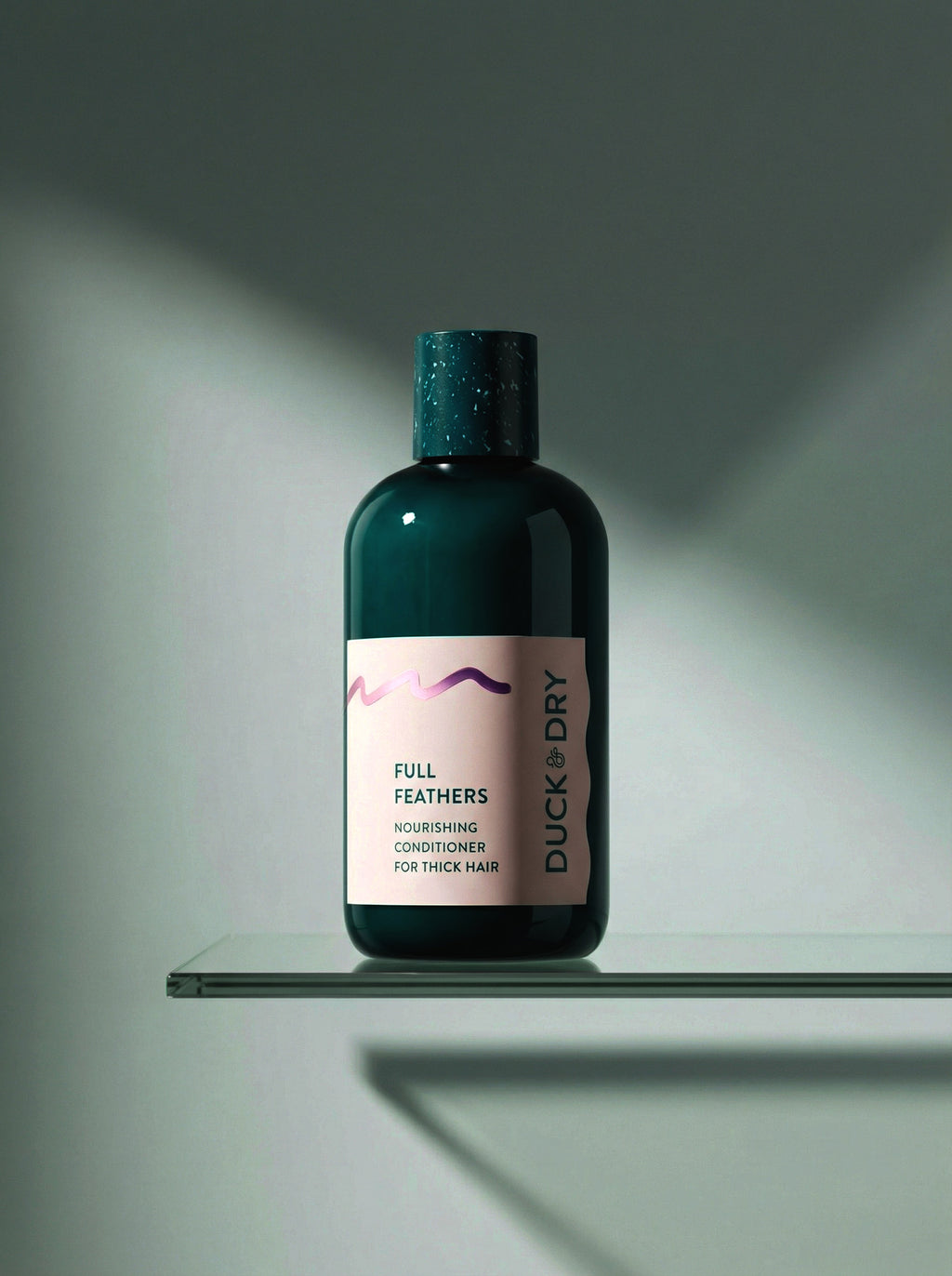 Bottle of Duck & Dry Full Feathers conditioner on a glass shelf with a gray background
