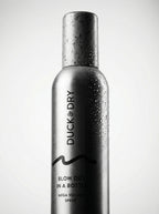 Silver spray bottle labeled 'Duck Dry' on a light gray background