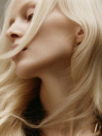 Close-up of a person with blonde hair, focusing on the hair texture and color.