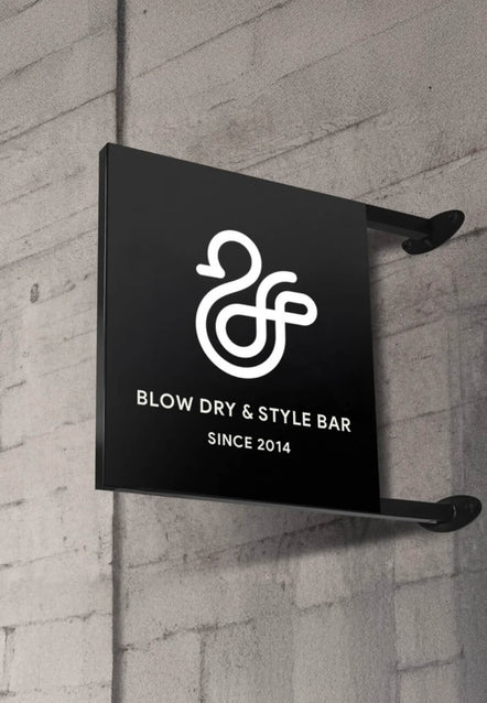Duck & Dry "Blow Dry & Style Bar" sign mounted on a concrete wall