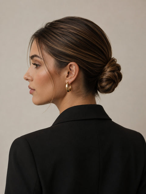 Side back view of a woman with dark brown hair in a low twisted bun updo